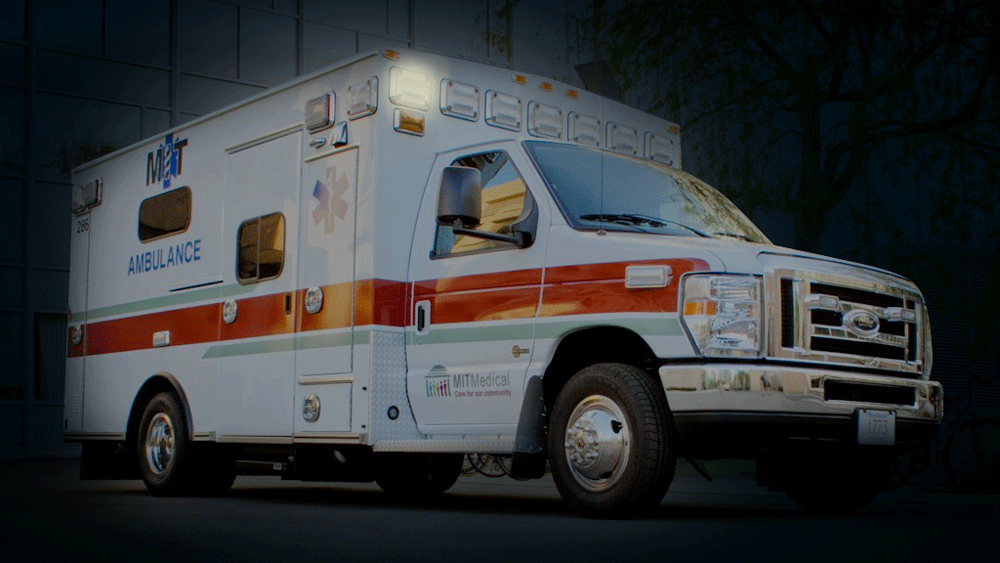 an MIT ambulance with lights flashing