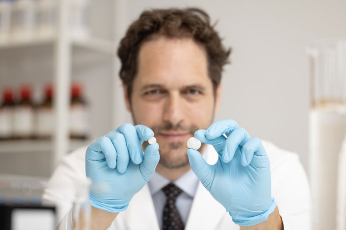 Aron Blaesi holds 2 tablets